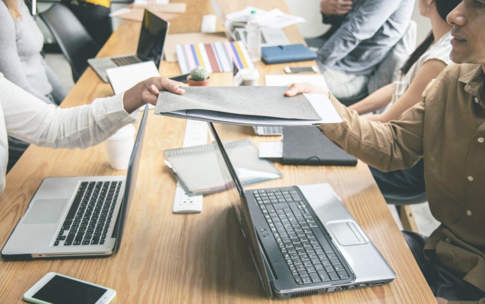 Business professionals reviewing financial documents and budget spreadsheets during a collaborative planning session